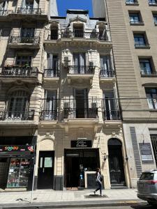 a woman walking down a street in front of a building at Recoleta 680 in Buenos Aires +16 photos