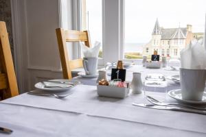 a table with plates and utensils on top of it at Number 7 Guest House in Whitby