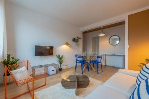 a living room with a couch and a table at Two bedroom apartment near shops & tram in Villeneuve d'Ascq