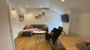 a living room with a couch and a table at Marina 2 in Sesvete