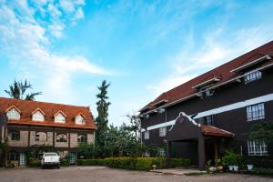 a building with a car parked in front of it at Gerbera staycation in Nairobi