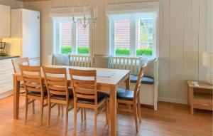 a kitchen and dining room with a table and chairs at Gorgeous Home In Risør With Wifi in Risør