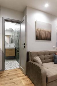 a room with a couch and a bathroom with a sink at Cozy Quiet City Center Apartment in Klaipėda +9 photos