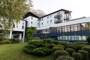 a building with a garden in front of it at Hotel Alp in Bovec