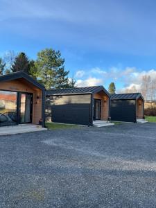 a house with two garages in a parking lot at Willa Rauha E, minikoti saunalla, iso parkkialue in Lumijoki