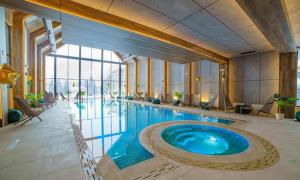 a large swimming pool in a building with a large pool at Maršal, Titova vila in Zlatibor