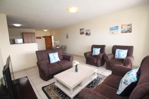 a living room with couches and a coffee table at Michael Point 6 in Shelly Beach