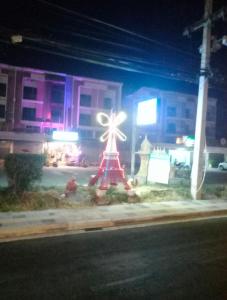 a windmill on the side of a street at night at Swiss Style Guesthouse in Cha Am