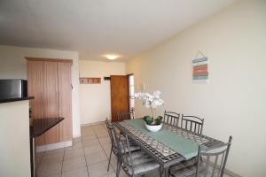 a kitchen and dining room with a table and chairs at Michael Point 6 in Shelly Beach