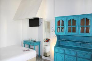 a bedroom with a blue cabinet and a bed at Urban Suites in Aveiro