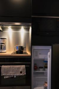 a kitchen with an open refrigerator and a stove at Willa Rauha 2B, minikoti, wifi, ei saunaa in Lumijoki