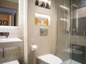 a bathroom with a shower and a toilet and a sink at Arran Shores Luxury Shorefront Apartment 3 in Lamlash