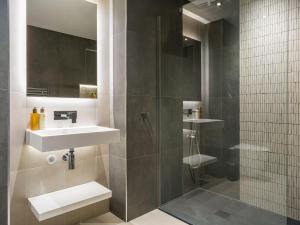 a bathroom with a sink and a shower at Arran Shores Luxury Shorefront Penthouse Suite 11 in Lamlash +26 photos