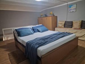 a bedroom with a large bed with blue pillows at Casa Rita-Superior Room in Giarre +11 photos