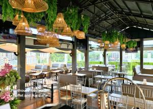 a restaurant with tables and chairs and lights at Citylight Hotel in Baguio