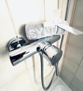 a chrome shower faucet in a bathroom with towels at Annika1 in Tinnum