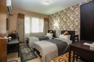 Llit o llits en una habitació de Nirvana Home