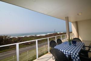 a table on a balcony with a view of the ocean at Michael Point 6 in Shelly Beach