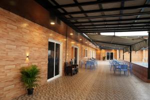 a lobby with tables and chairs in a building at Hashtag Hive in Puducherry