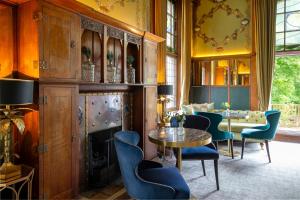a dining room with blue chairs and a table at Elmbank York, Tapestry Collection by Hilton in York