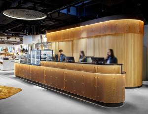 people sitting at a counter in a restaurant at H2 Hotel Saarbrücken, Trademark by Wyndham in Saarbrücken