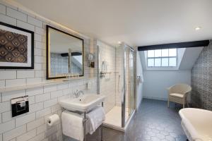 a bathroom with a sink and a shower at Elmbank York, Tapestry Collection by Hilton in York +77 photos