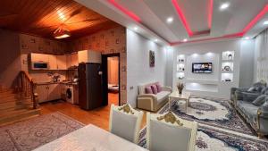 a kitchen and a living room with a couch and a table at Gabala Dreams Villa with Large Garden in Gabala