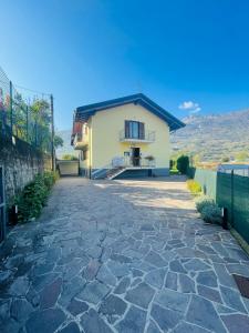 a house with a stone driveway in front of it at Countryhouse Verso in Rovereto