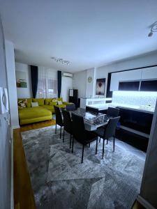 a living room with a table and chairs and a couch at Pleasure Lux1 Apartment in Belgrade