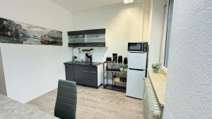 a kitchen with a white refrigerator and a counter at City Apartment - 2SZ - 1BD - Küche - Netflix in Karlsruhe