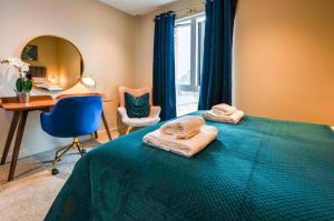 a bedroom with a bed and a desk and a mirror at York Central No 3, within the city walls, free parking in York +14 photos