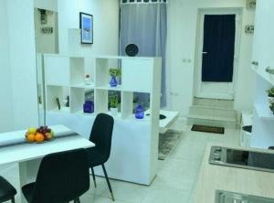a white room with a table and chairs in a room at Charming Sinj Town Studio Apartments in Sinj +3 photos