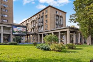 a large building with a large screen in front of it at Garsoniera LUX Piata Natiunile Unite in Bucharest
