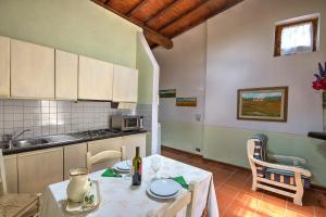 a kitchen with a table with a bottle of wine at Borgo Romena in Pratovecchio