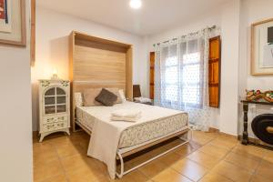 a bedroom with a large bed in a room at La petite maison de Nadette 2 in Gandía