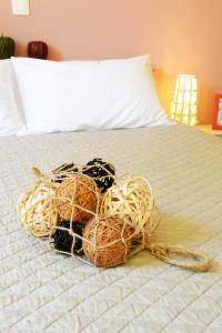 a pile of balls of yarn sitting on a bed at Esperides in Marathopoli