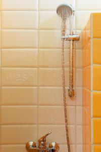 a shower with water coming out of it next to a sink at Esperides in Marathopolis