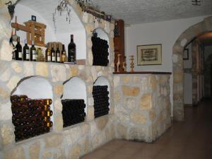 a bunch of wine bottles on a wall at Erbhof Wegleitner in Illmitz