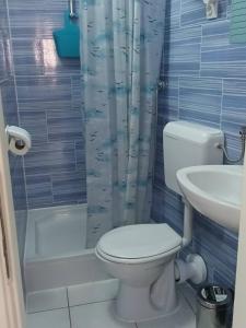 a bathroom with a toilet and a sink and a shower at Cozy Studio Apartments with Terrace Near Kaštela Promenade in Kaštela