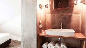 a bathroom with a sink on a wooden shelf at Dutchen Park Duynzoom in De Koog +27 photos