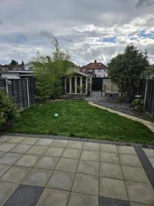 a yard with a ball on the grass at Large Bungalow to sleep up to 8 in Slough