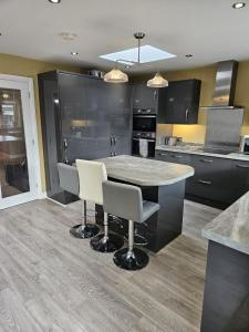 a kitchen with a table and chairs in it at Large Bungalow to sleep up to 8 in Slough