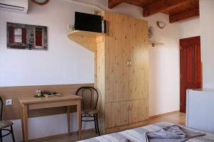 a bedroom with a bed and a desk and a room at Vila Anna in Veľký Meder