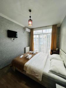 Postel nebo postele na pokoji v ubytování Hotel Marioni