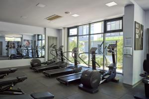 a gym with several treadmills and elliptical machines at Apartament Atlantis by ALZ in Mamaia Nord