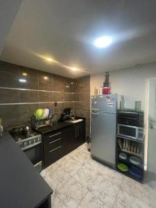 a kitchen with a stainless steel refrigerator and a stove at Casa Moderna San Rafael - 2 DORMITORIOS Y SALA MULTIMEDIA CON YOUTUBE in San Rafael