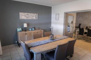 a dining room with a wooden table and chairs at Marga's Gästehaus in Mehring