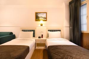 Postel nebo postele na pokoji v ubytování Summit Mall Stone Hotel