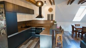 a kitchen with blue cabinets and a stove top oven at Apartman Vulcano in Zvolen