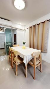 een eetkamer met een tafel en wat stoelen bij Airport House BKK in Ban Khlong Lat Bua Khao